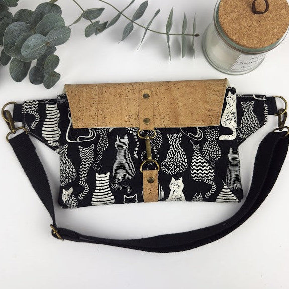 Belt bag/ sling back with black and white cats and a cork flap.